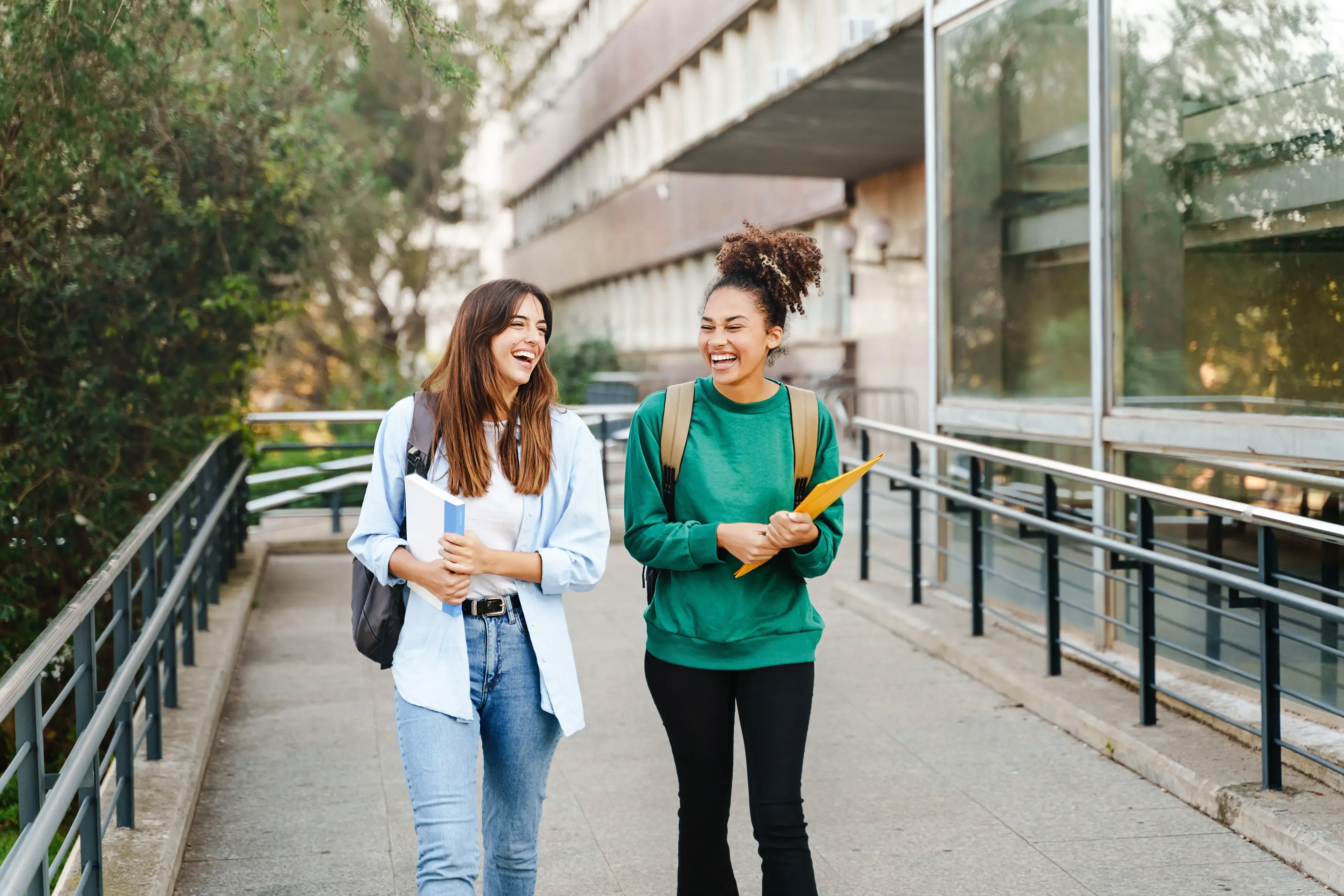 Two friends celebrating together — DFCU Member Referral Program