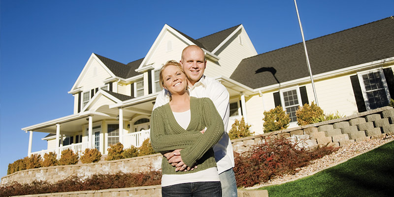 couple standing outside their home