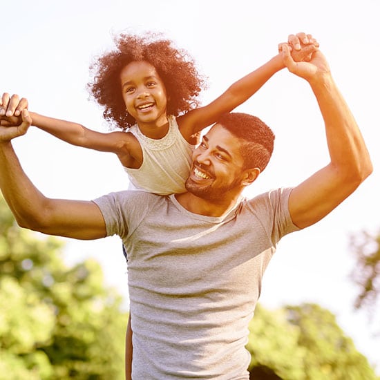 father with daughter on his shoulders