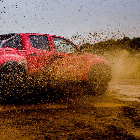 truck spraying mud from tires, enjoying the off-road