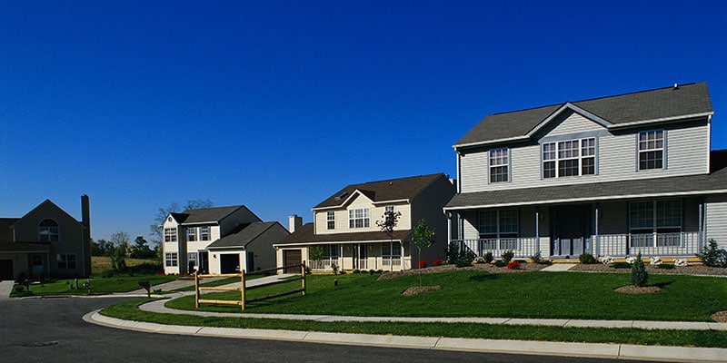 rural neighborhood exterior with fields in the background