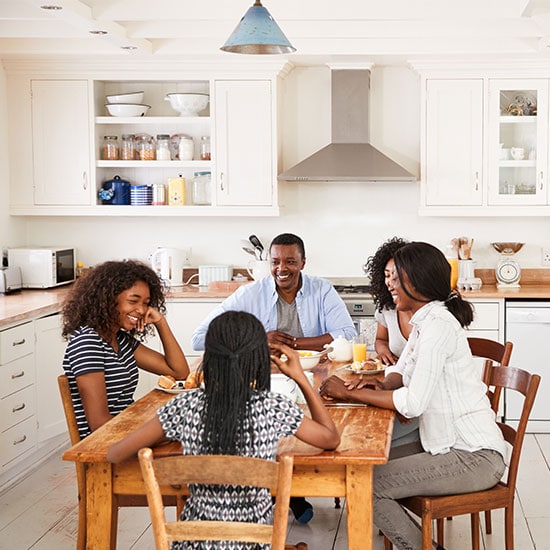 family enjoying their dinner together at home