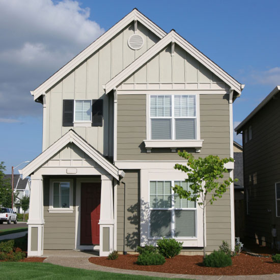 small, new home with a red door