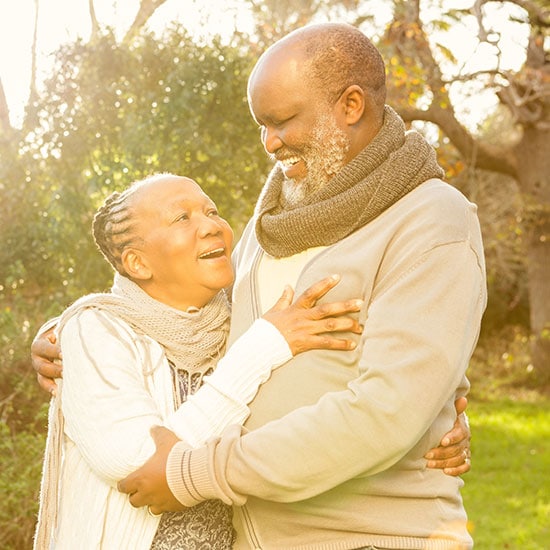 senior couple hugging in the park