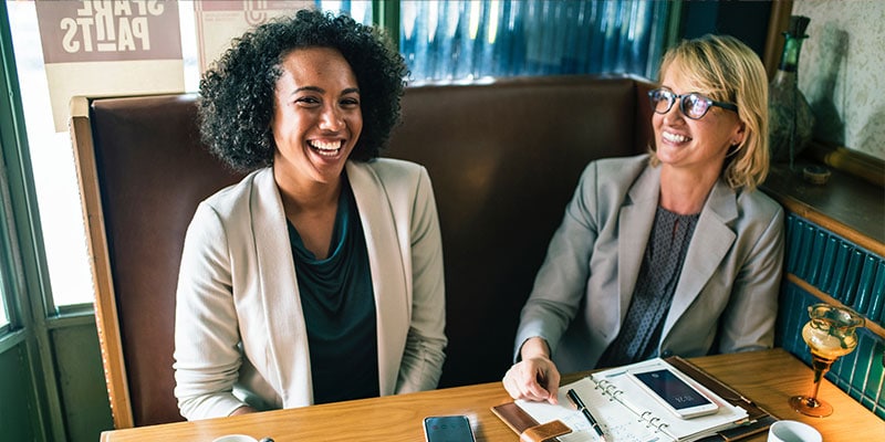 two women in suit jackets, out for a business lunch