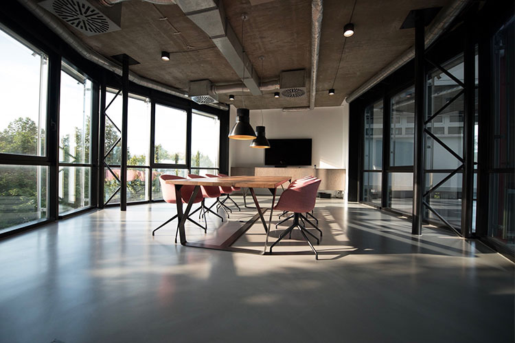 empty conference room with full height windows and natural lighting