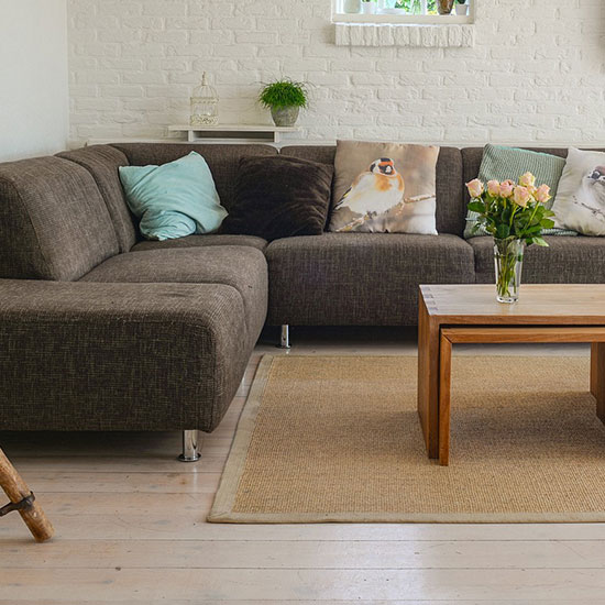 interior living room space with couch and flowers on a coffee table