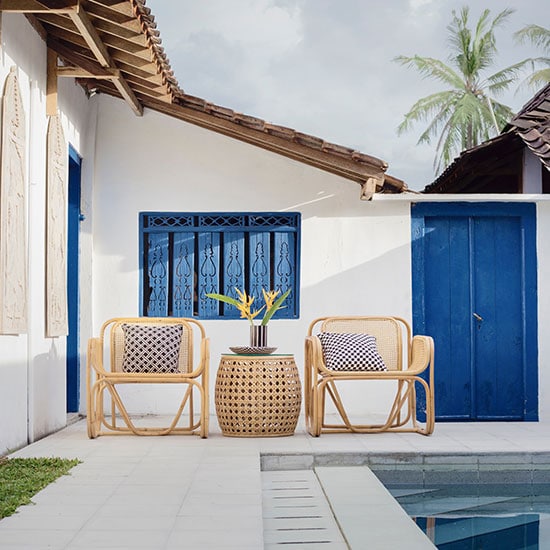 outdoor patio chairs and table, next to a private pool