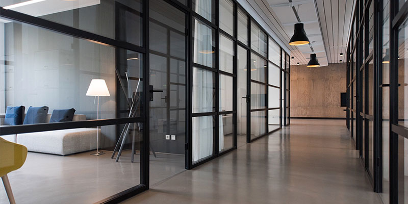empty office hallway with a visible quite space including a couch
