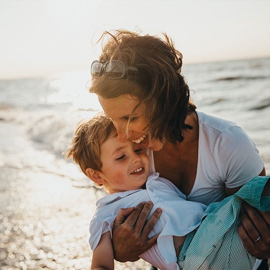 mother holder her son at the beach