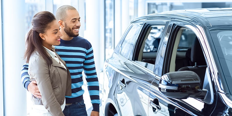 couple looking at a new car together