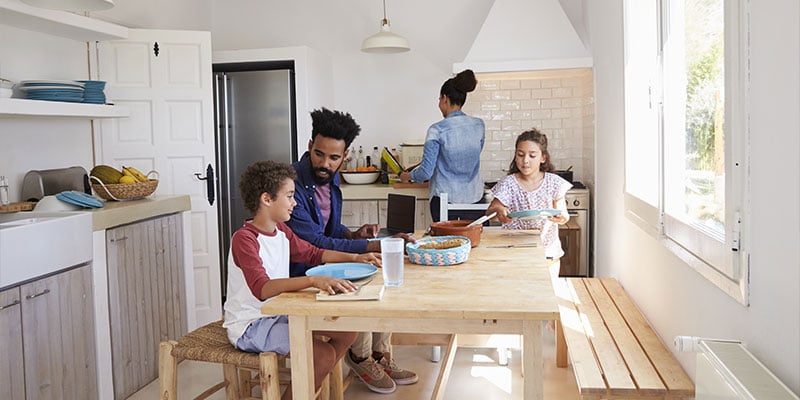 happy family eating together in their kitchen