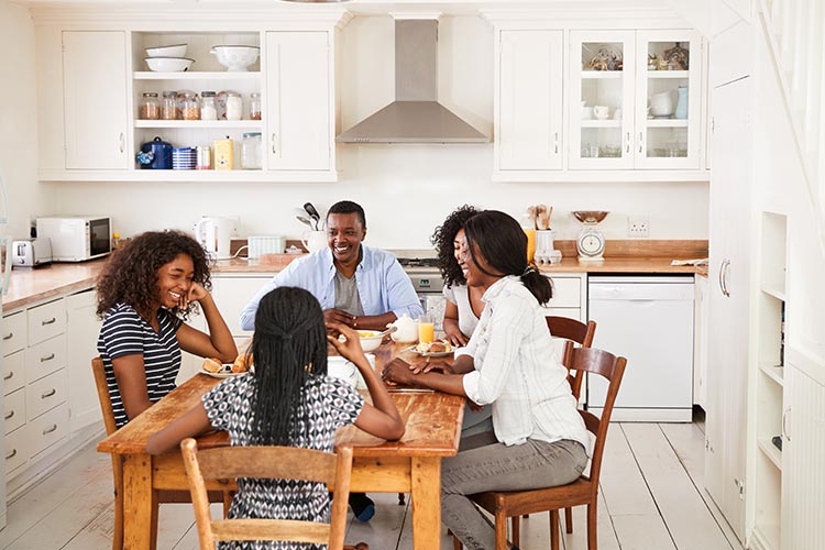 family enjoying their dinner together at home