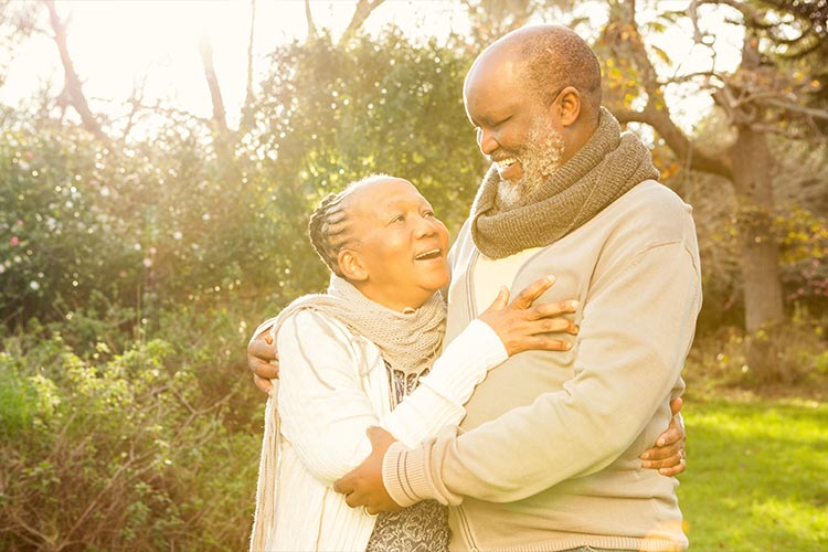 senior couple hugging in the park