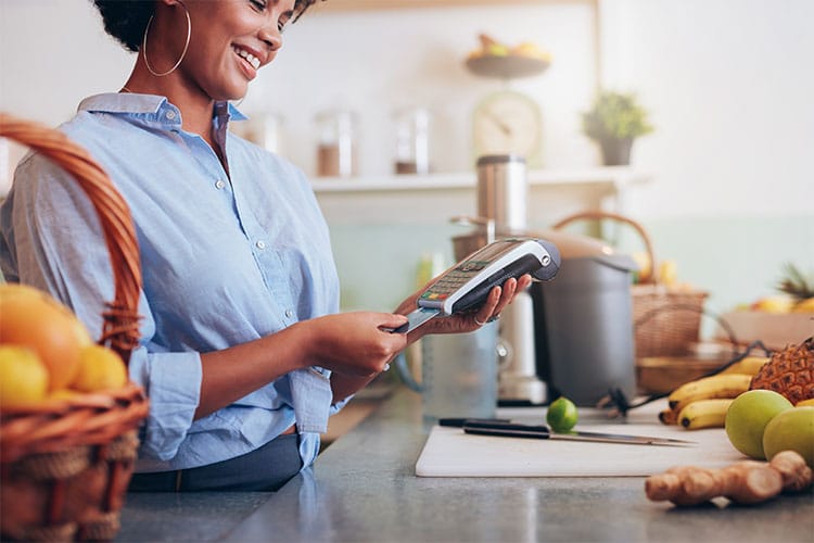 woman using her debit card to make a purchase