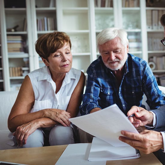 mature couple discussing options with a financial advisor