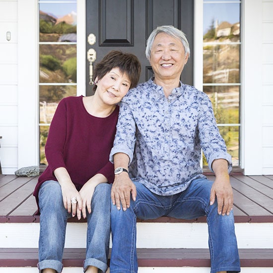 senior couple outside their home