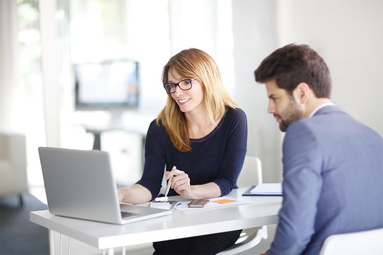 woman using a computer to reorder checks for a member