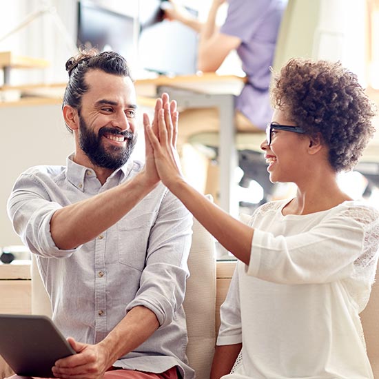 smiling coworkers high five