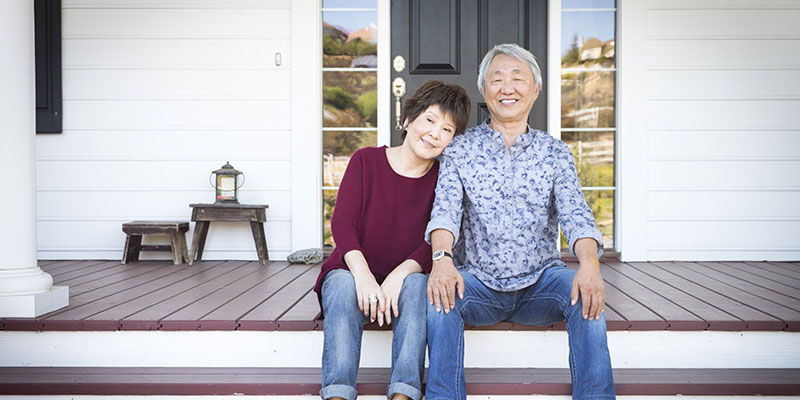 mature couple on the porch of their home