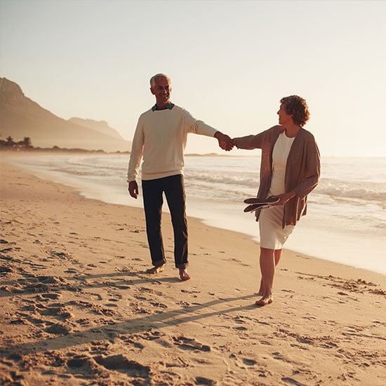 playful senior couple on beach