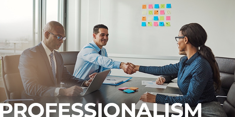 two business people shaking hands across a table while another one types on the computer. with the text overlay: Professionalism