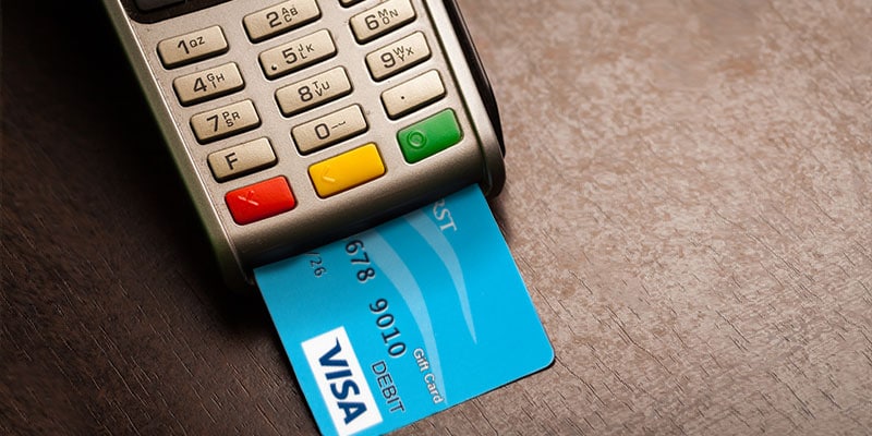 Deseret First Visa debit card inside a card terminal