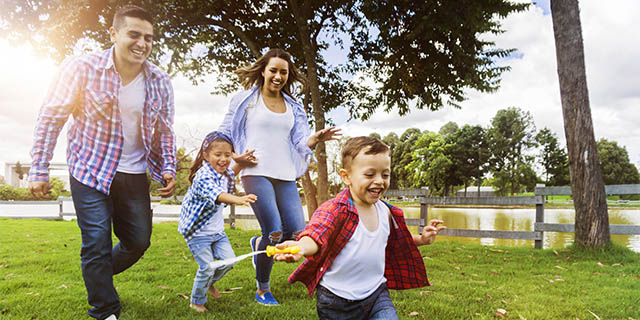 Latino family playing in a park