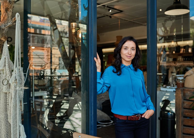 woman standing in the door way of a shop