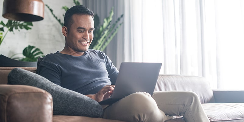 man reading articles on his laptop