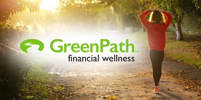 Woman walking down a road next to the GreenPath logo