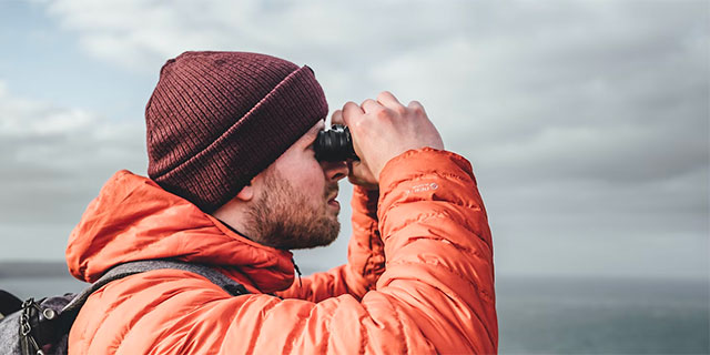 Man looking through binoculars