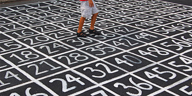 Numbers drawn on blacktop.