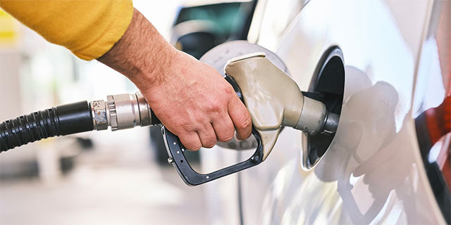 Man filling car with fuel.