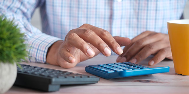 A man performing math on a calculator
