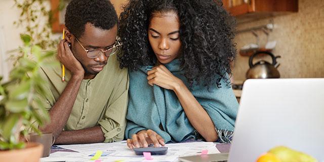 A couple making calculations from their budget.