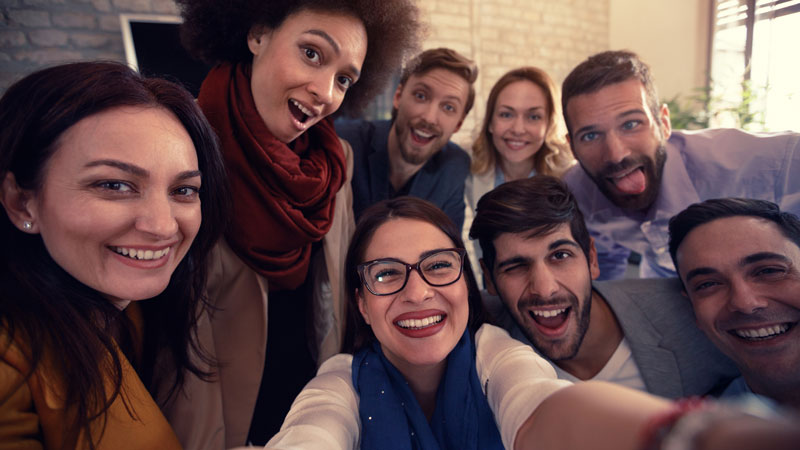 Several employees grouped together for a selfie